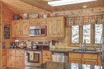 Black Bear Lodge kitchen with stainless Steel appliances and hickory cabinets. 